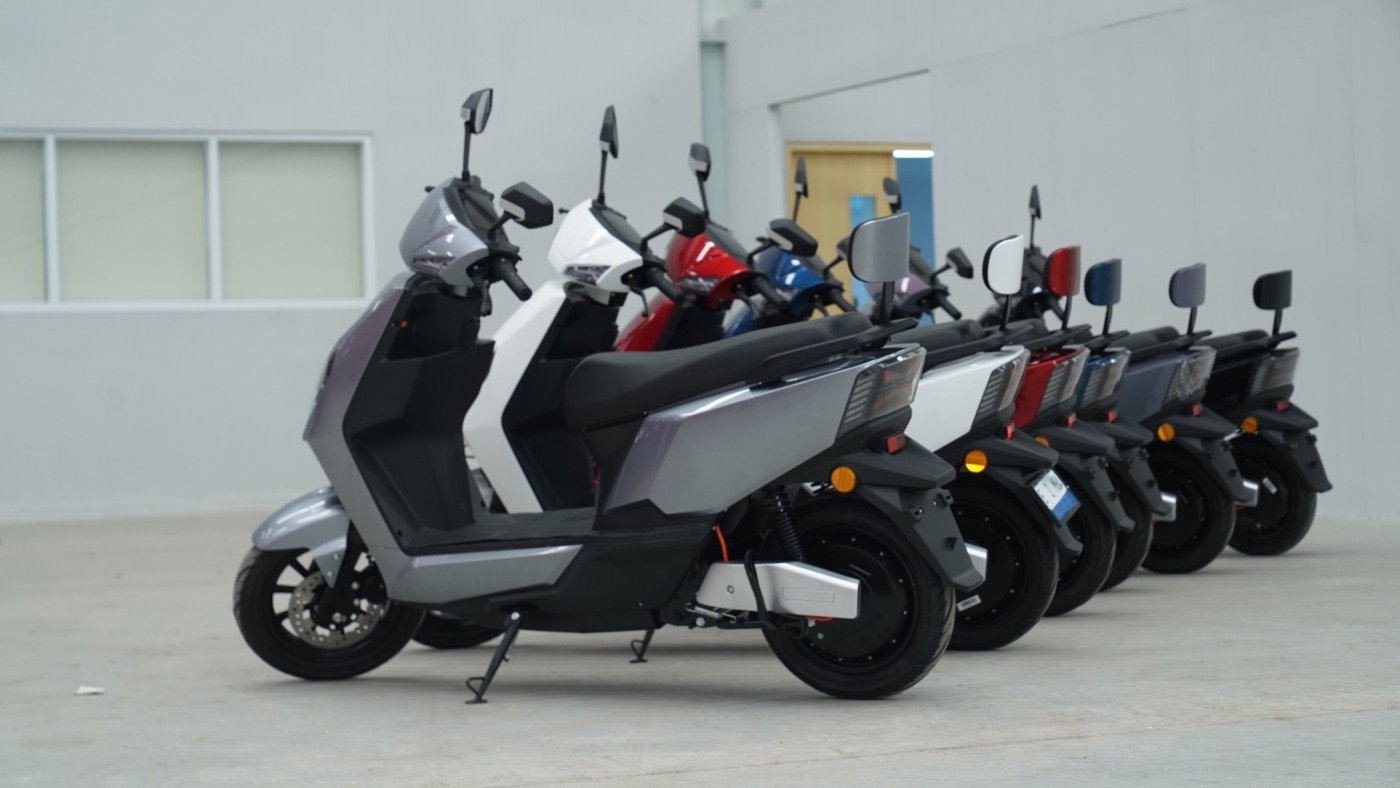 a row of eMOA scooters parked in a row