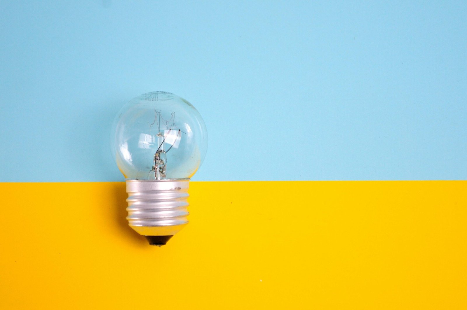 a light bulb bulb in a light bulb bulb on a yellow and blue background