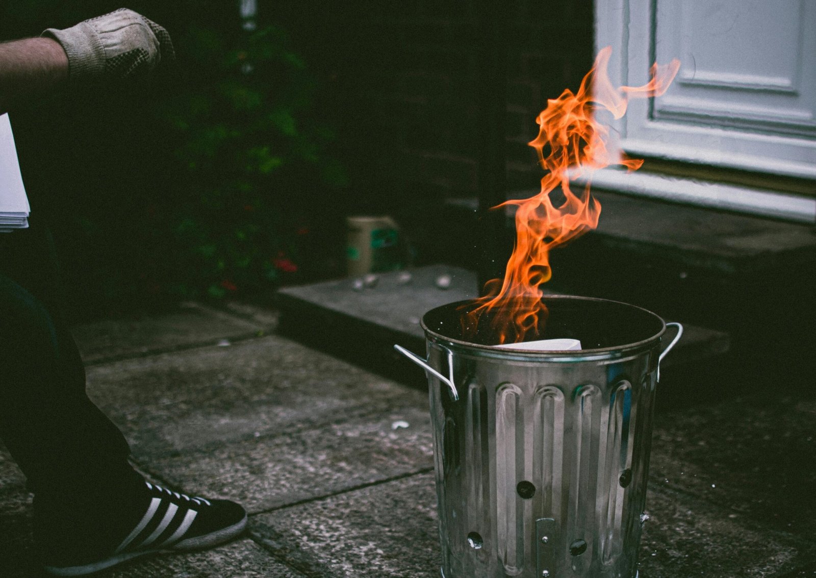 a person sitting on a bench in front of a fire