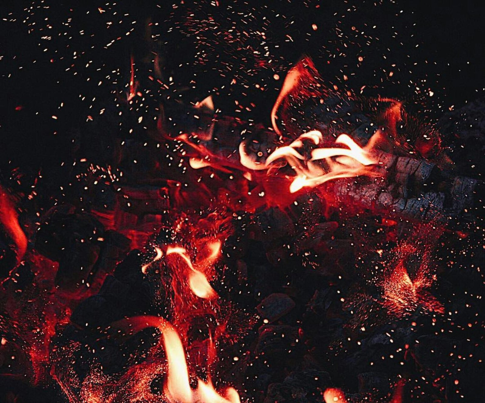 a fire burns in the night sky