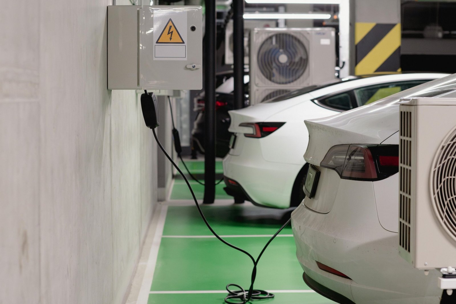 a car charging station with a car in the background
