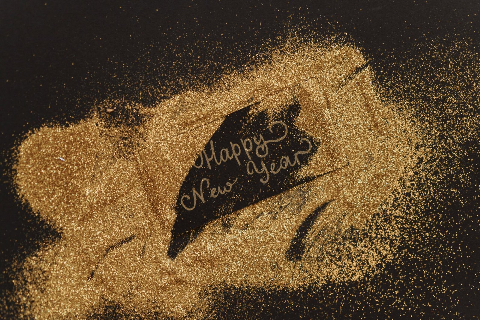 a happy new year's day message with gold dust scattered on top of it