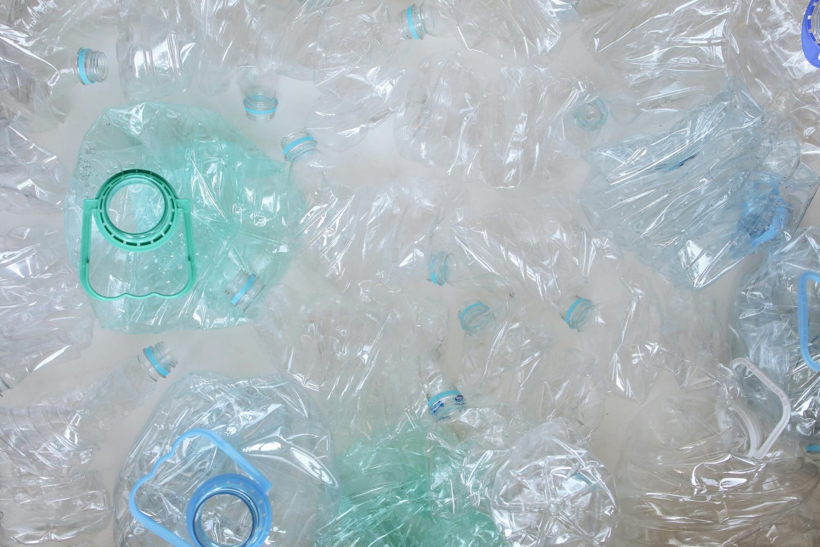 a bunch of plastic bottles with plastic lids ready for recycling