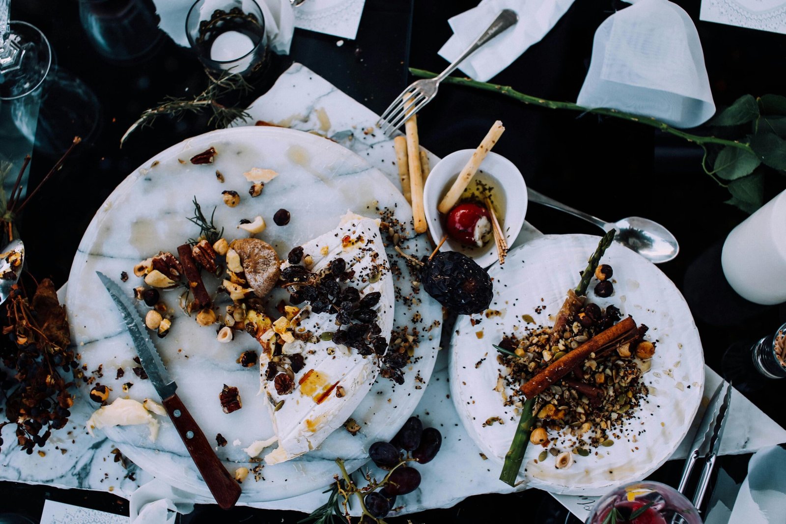 a messy table with a plate of food waste and utensils