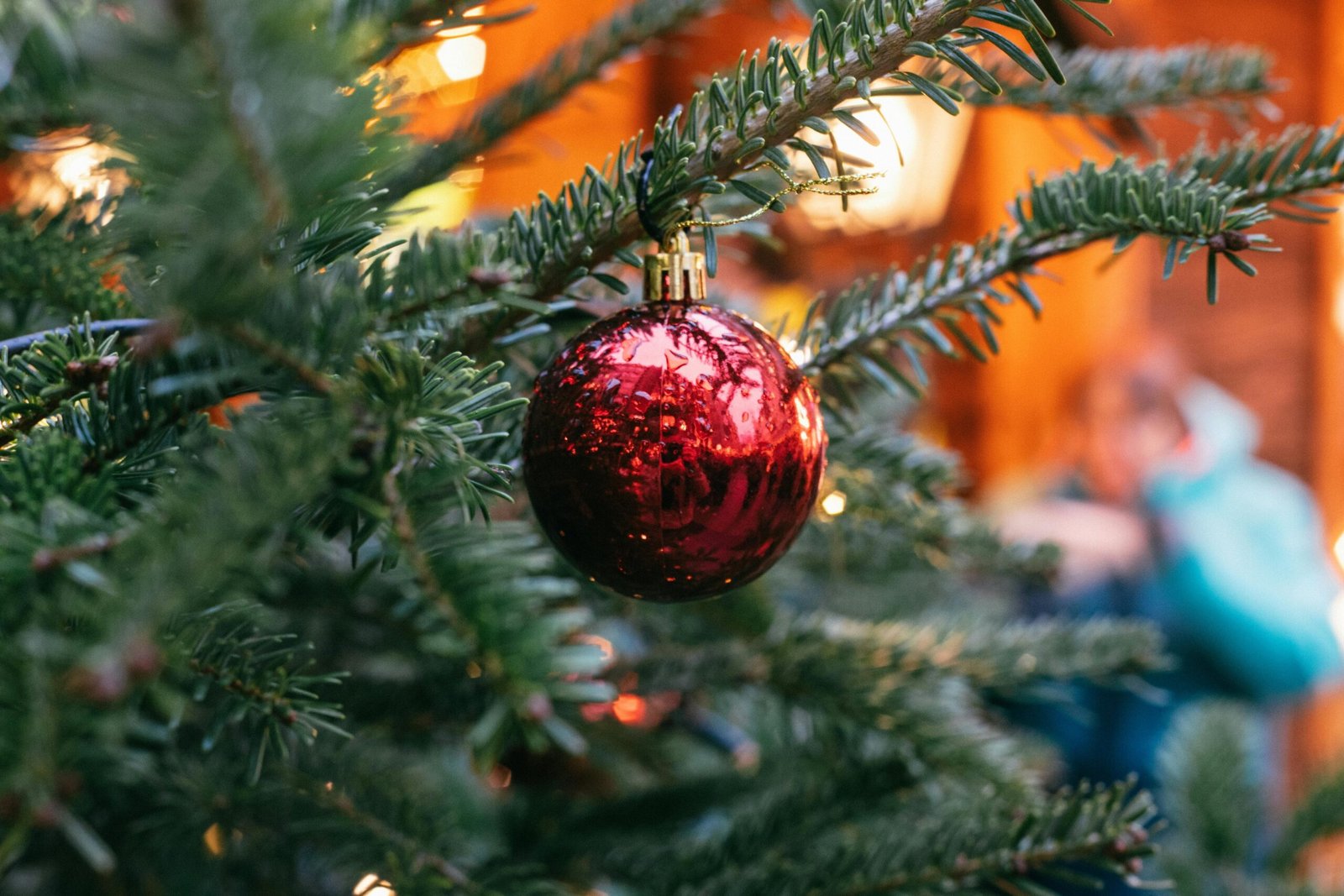 a christmas tree with a red ornament ball ornament