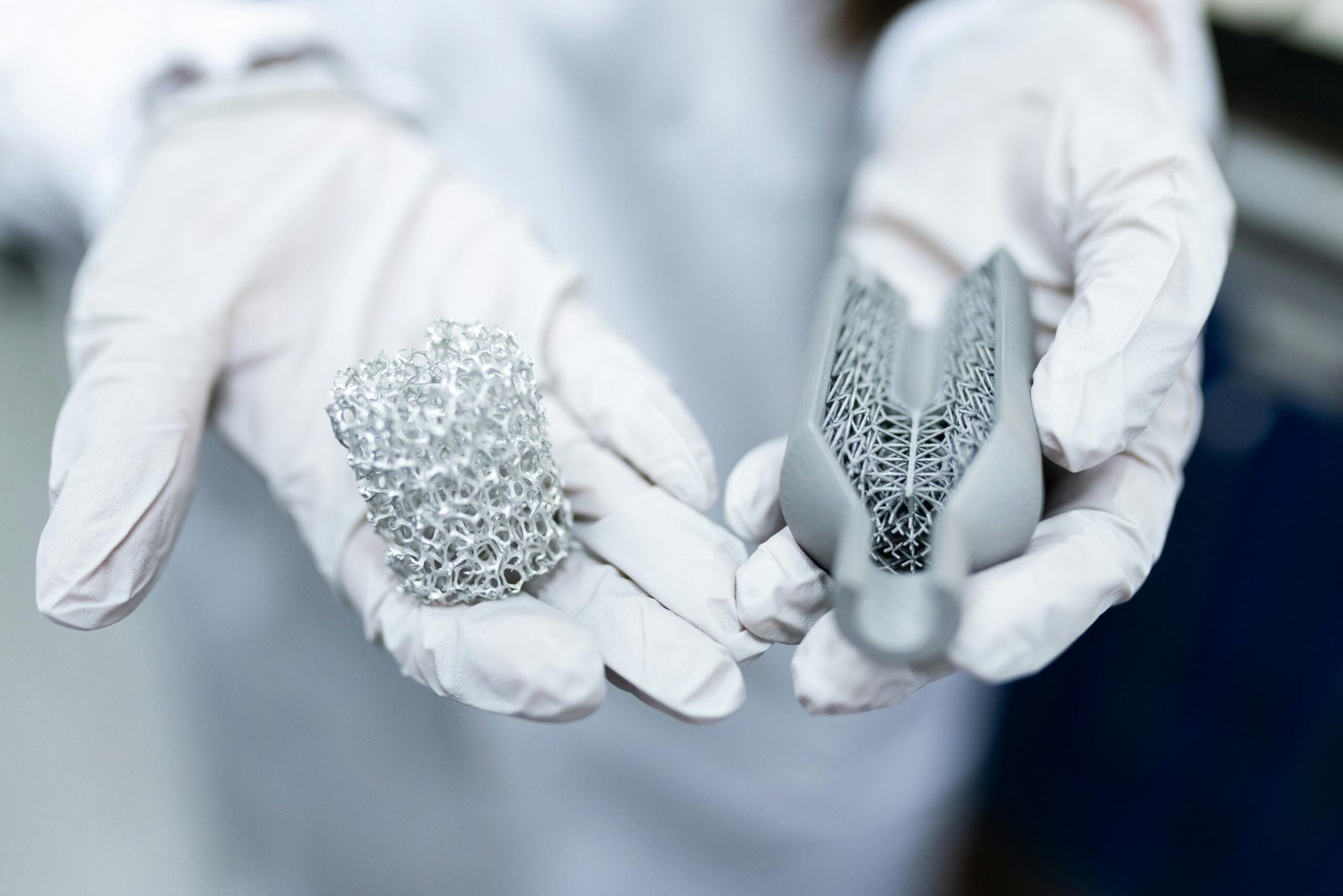 a person in white gloves holding materials to make batteries